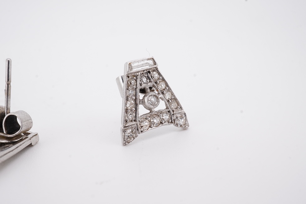 A pair of mid 20th century white metal and millegrain set diamond cluster set 'A' shaped ear studs(adapted from watch lugs?), set with round and baguette cut stones, 12mm, gross weight 3.2 grams.
